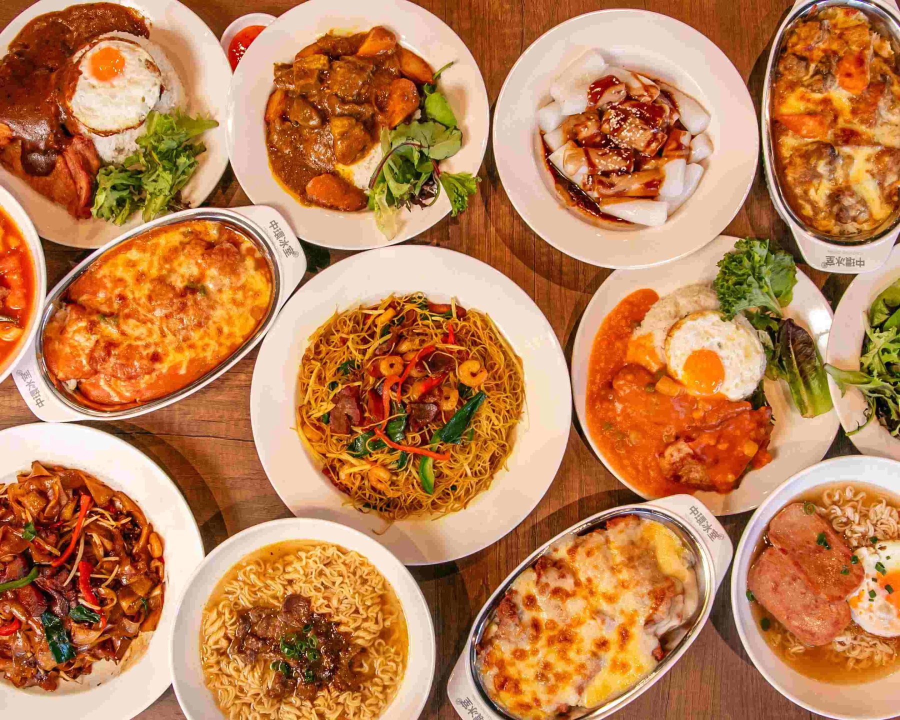 A spread of Hong Kong Central dishes — baked cheese rice, wok noodles, cheung fun and instant noodle bowls